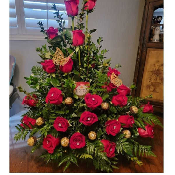 Tall arrangement of red roses with gold chocolates and butterfly picks