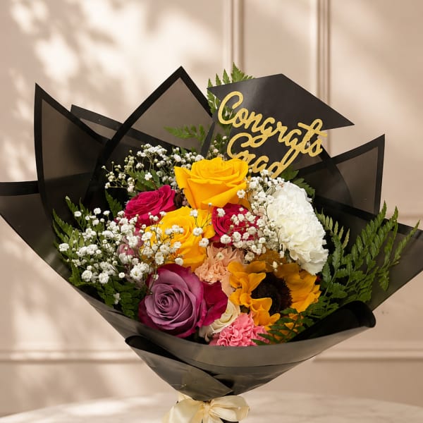 Bouquet of multicolored roses with a graduation topper and black wrap