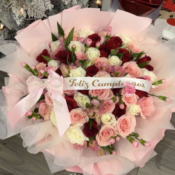 Pink and red rose bouquet with a birthday ribbon and bow