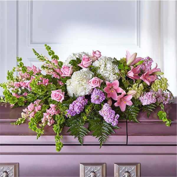 Pink and white floral casket spray with lilies and roses
