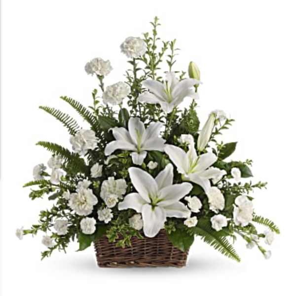 White lilies and carnations in a wicker basket