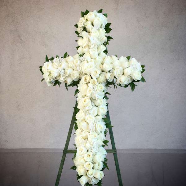 White rose cross on a standing easel