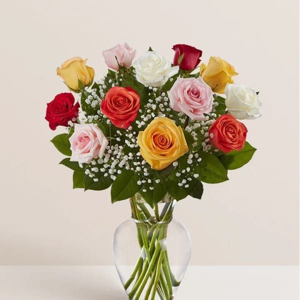 Mixed roses in a clear glass vase