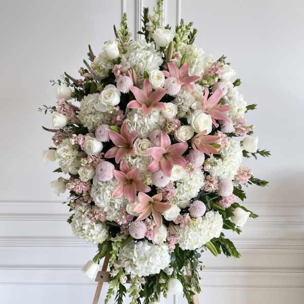 Large pink and white floral standing spray on an easel