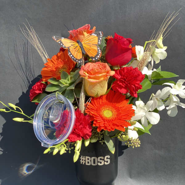 Bright mixed bouquet in a black tumbler with a clear lid and "#BOSS" text.