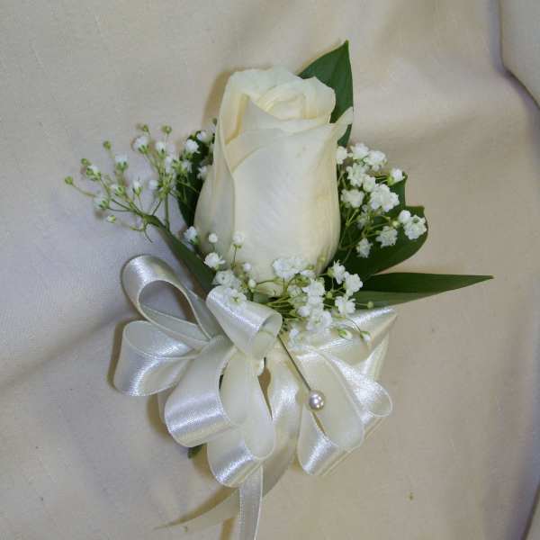White rose boutonniere with baby's breath and satin ribbon