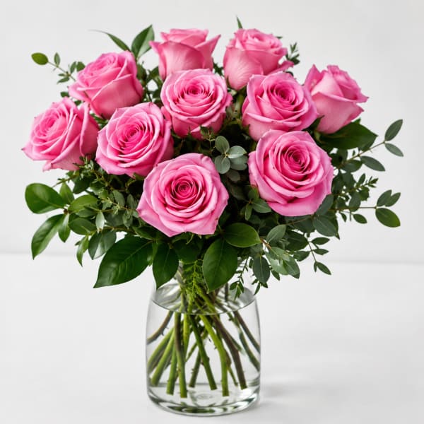 Pink roses arranged in a clear glass vase