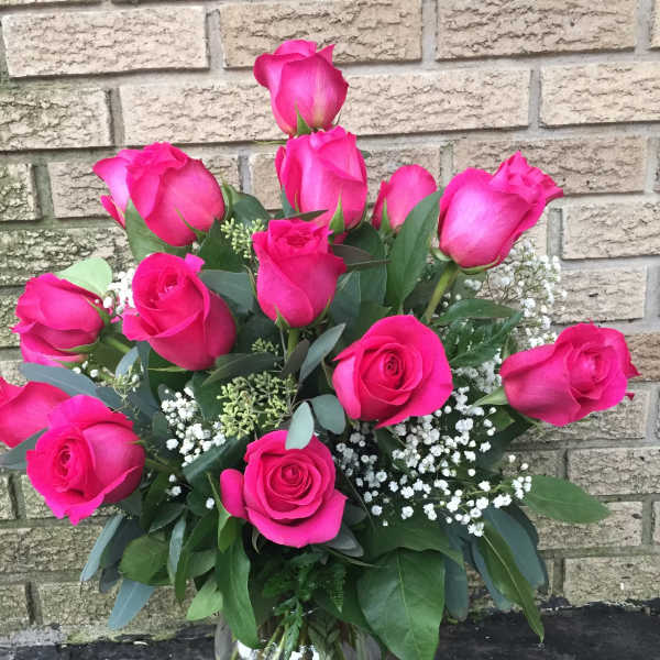 Bouquet of hot pink roses in a clear glass vase