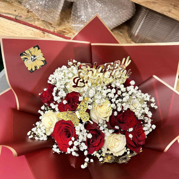 Bouquet of red and white roses with a gold Happy Birthday topper
