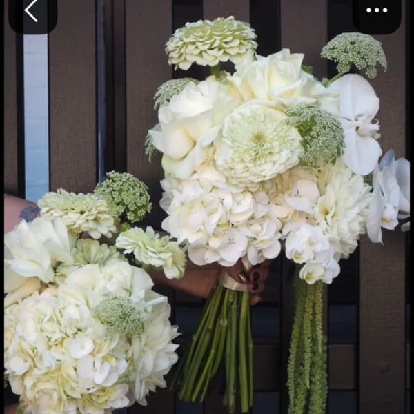 White wedding bouquets with roses, hydrangeas, and orchids