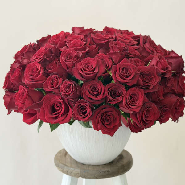 Large bouquet of red roses in a white vase