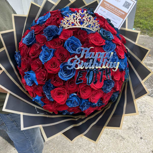 Red and blue rose bouquet with a jeweled crown and birthday topper