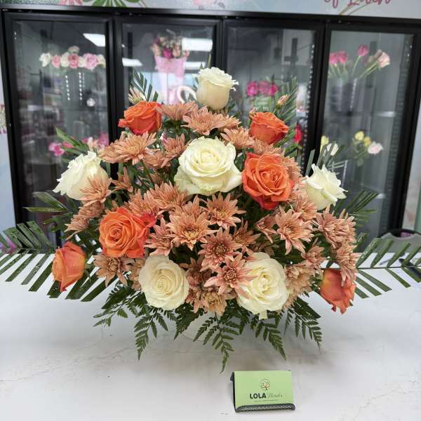 Arrangement of orange and white roses with peach chrysanthemums