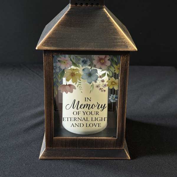 Bronze lantern with a memorial candle and pastel floral print