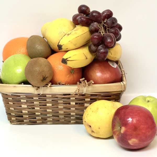 Basket of assorted fruit with grapes, bananas, apples, oranges, and kiwis
