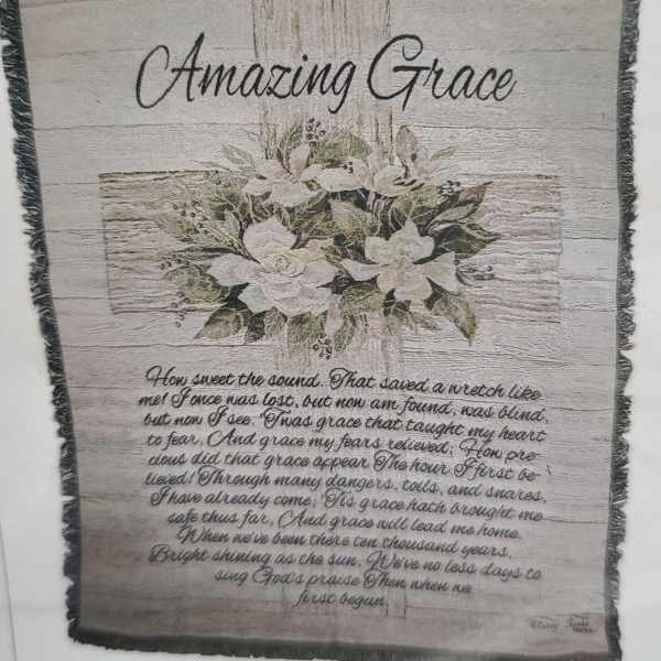 Framed wall hanging with white flowers and the words Amazing Grace