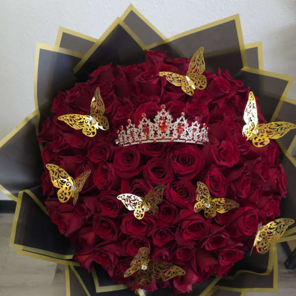 Heart-shaped bouquet of red roses with gold butterfly accents and a jeweled tiara