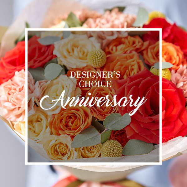 Bouquet of red, orange, and cream roses with peach blooms, shown with Designer's Choice Anniversary text overlay.