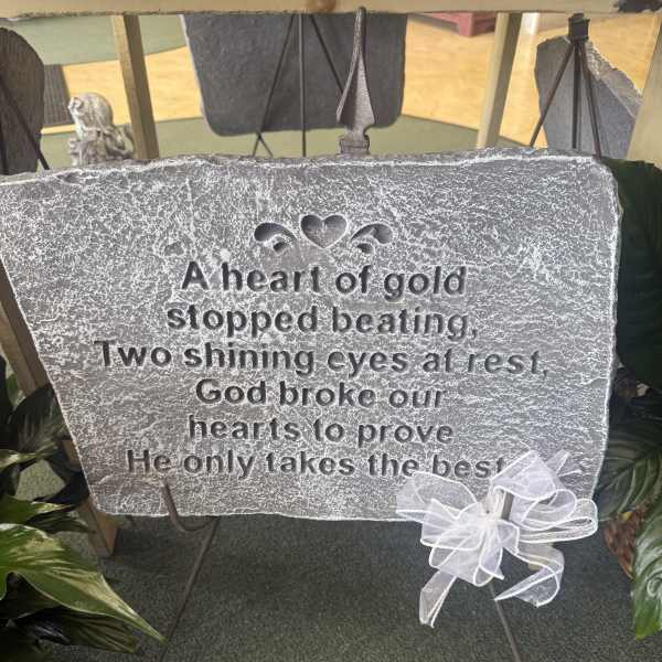 Memorial plaque on an easel with a white ribbon bow