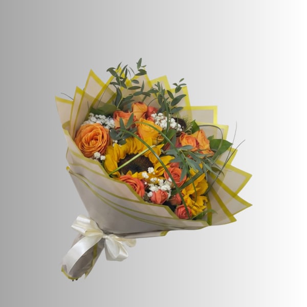 Bouquet of orange roses and sunflowers wrapped in cream paper