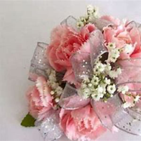 Pink floral bouquet with sheer ribbon and small white filler flowers