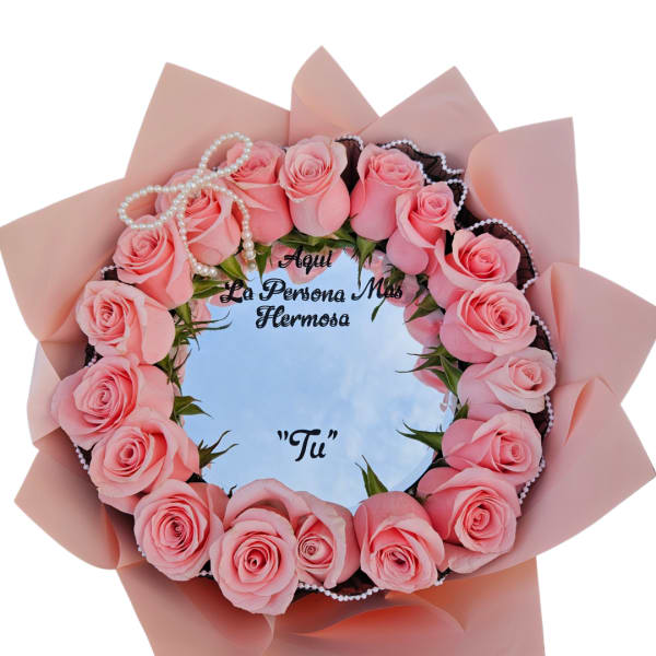 Pink rose bouquet arranged in a circular frame with a pearl bow