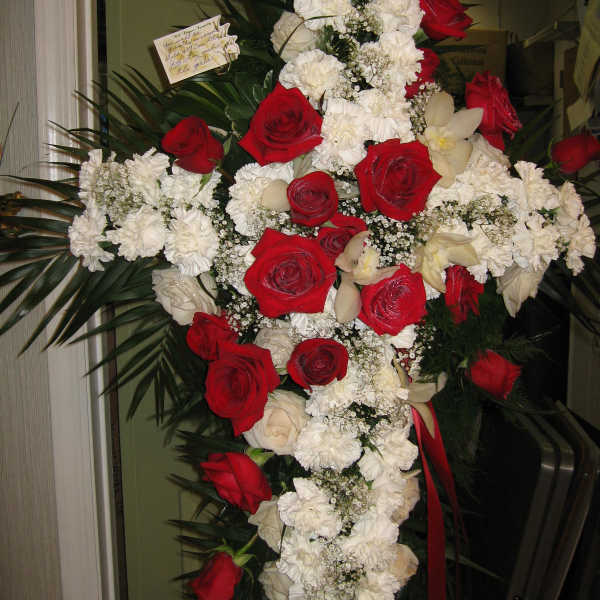 Cross-shaped floral spray with red roses and white carnations