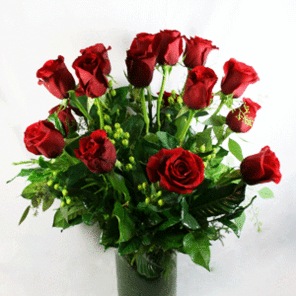 Red roses arranged in a clear glass vase