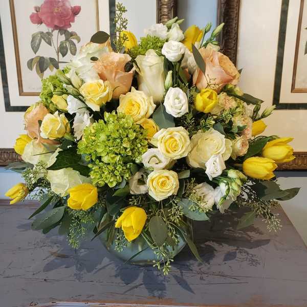 Mixed bouquet of yellow and white flowers in a low vase