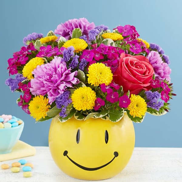 Colorful mixed bouquet in a yellow smiley-face container