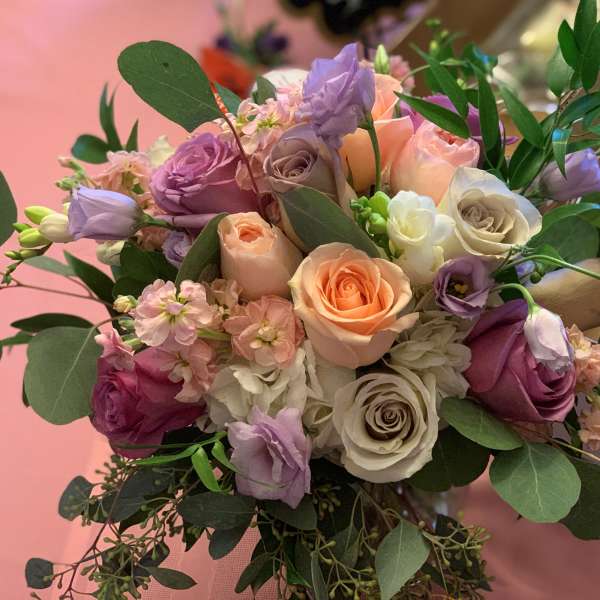 Bouquet of pastel roses and lavender blooms with greenery