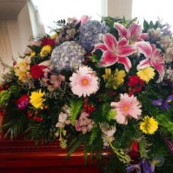 Large mixed floral spray with lilies, daisies, and roses