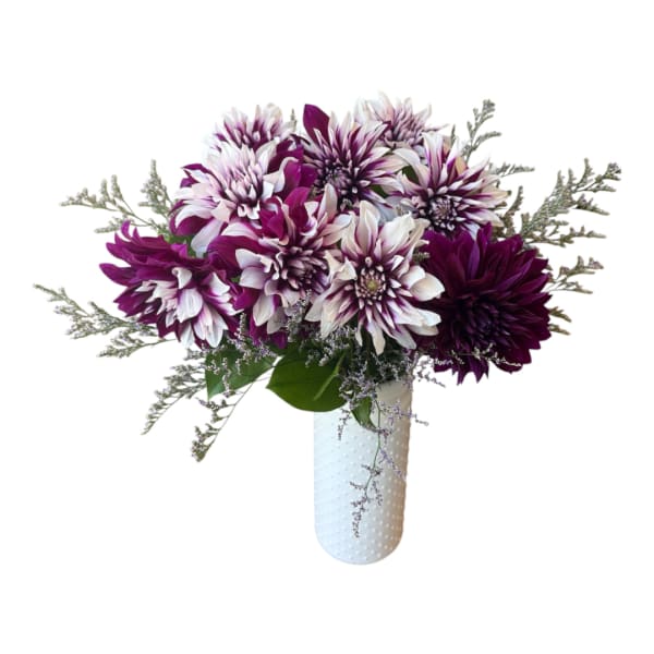 Purple and white dahlia bouquet in a white vase