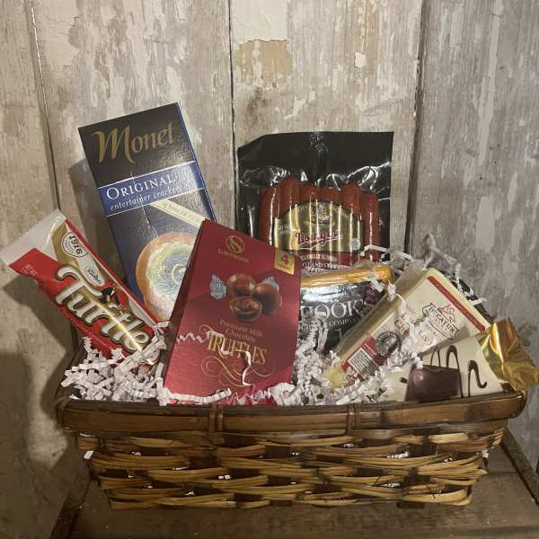 Gift basket with assorted chocolates and packaged snacks in a wicker basket