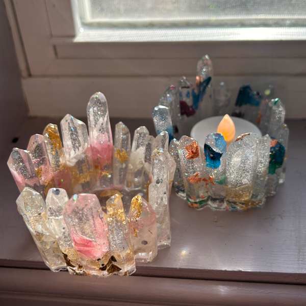 Two glittery crystal candle holders on a windowsill