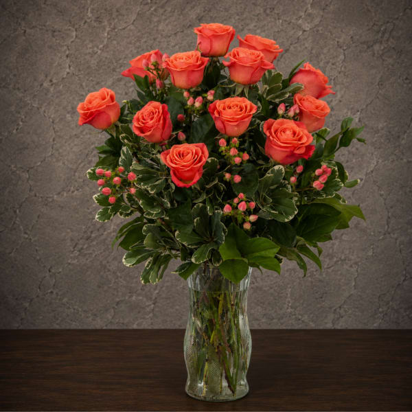 Coral rose bouquet in a clear glass vase