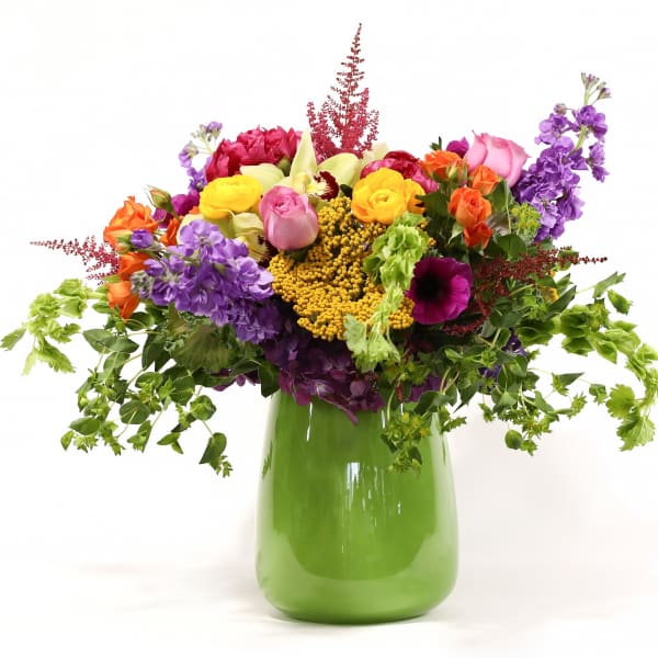 Colorful mixed bouquet in a green vase