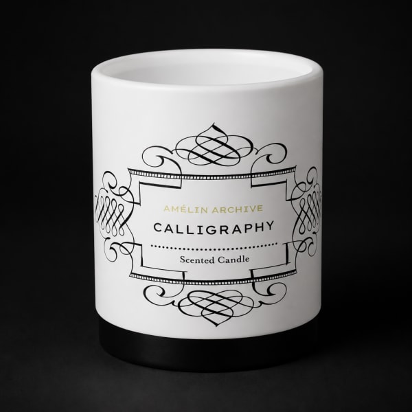 White scented candle in a black-and-white decorative jar