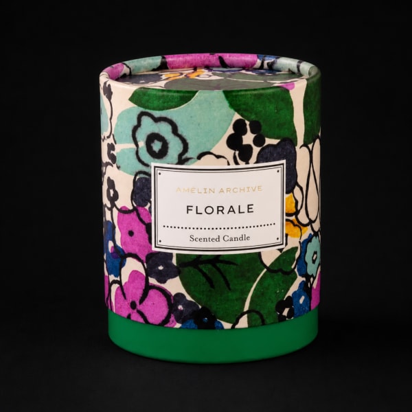 Floral-scented candle in a colorful patterned container