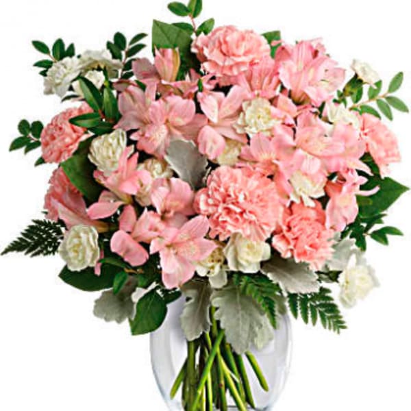 Pink and white bouquet in a clear glass vase