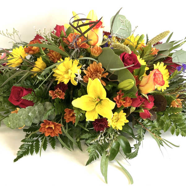 Mixed bouquet with yellow lilies, red roses, and orange daisies