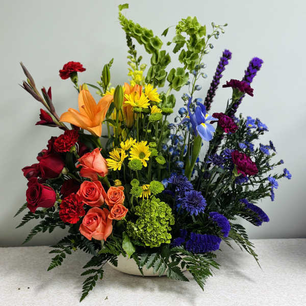 Colorful mixed flower arrangement in a low white bowl