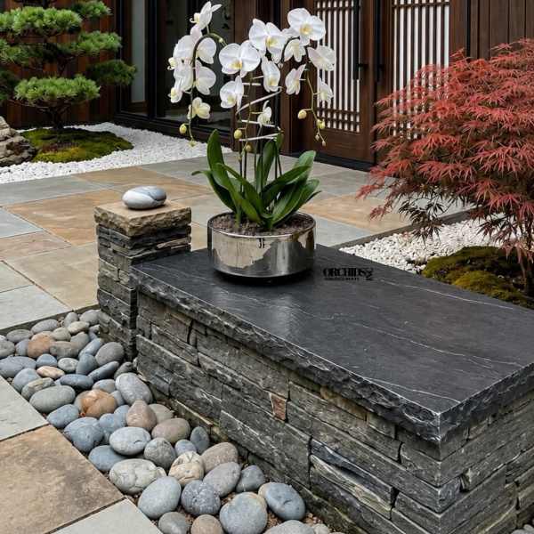 White orchid plant in a metallic pot on a stone bench