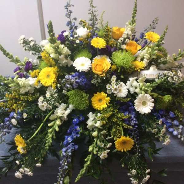 Large mixed floral spray with yellow, white, purple, and blue blooms
