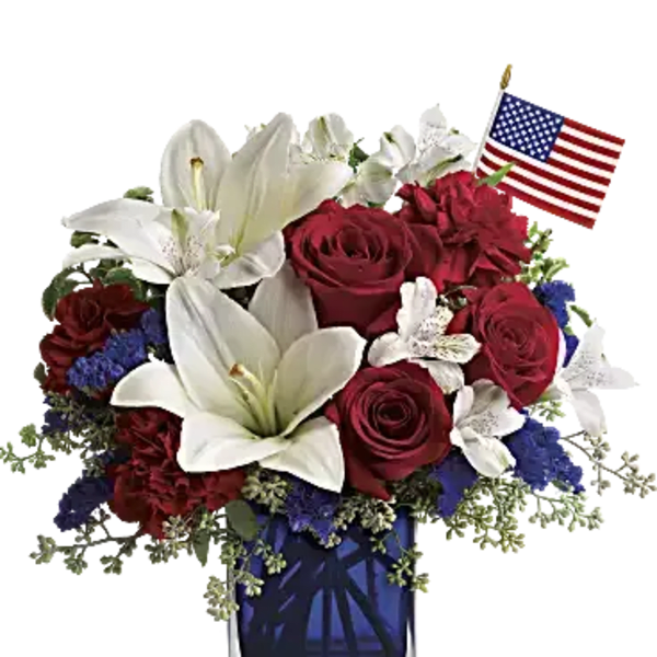 Red roses and white lilies in a glass vase with a small American flag