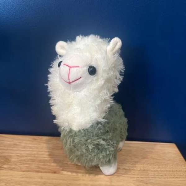 Plush llama toy with a white fluffy head and green body
