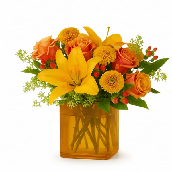 Orange roses and yellow lilies in an amber glass vase