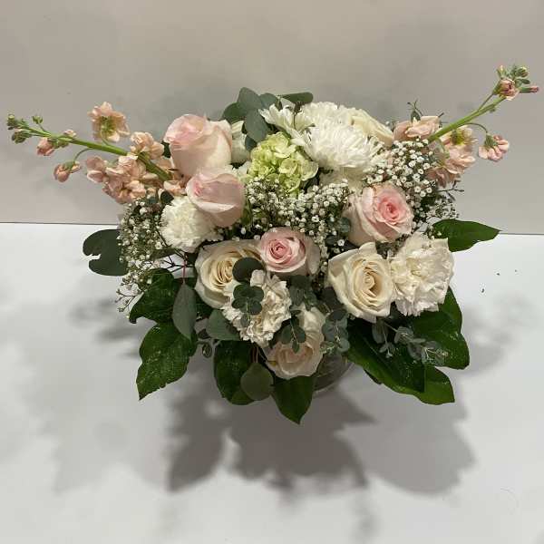 Blush and white rose bouquet in a glass vase