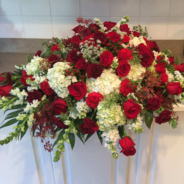 Large red and white floral arrangement with roses and carnations