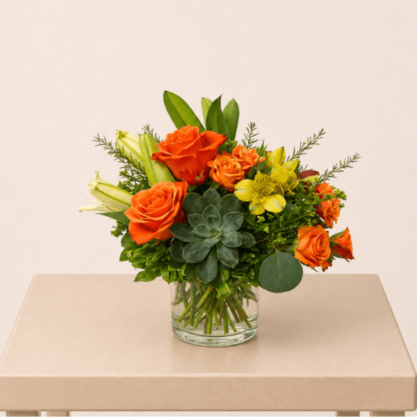 Orange and yellow mixed bouquet in a clear glass vase